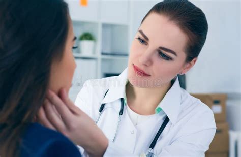 Young Female Doctor Palpating Lymph Nodes Of A Patient Medical Exam