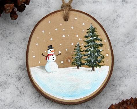 A Wooden Ornament With A Snowman On It