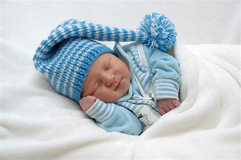 Baby In Blue Shirt And Cap Sleeping On White Textile Hd Wallpaper