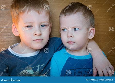 Two Little Brother Sitting In Each Other S Arms Stock Image Image Of
