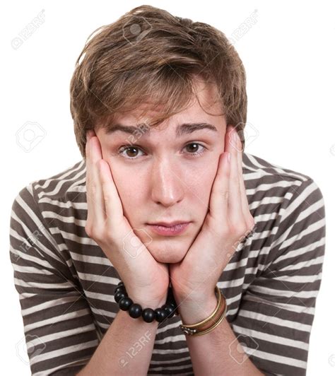 Bored Young Man With Hands On Face Over White Background Stock Photo