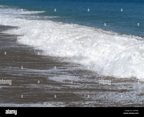 A Wave Hitting The Beach Stock Photo Alamy