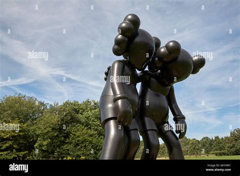 Kaws Along The Way Black Wooden Sculpture In The Yorkshire Sculpture