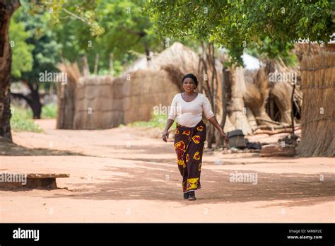 Zambian Women In Traditional Patterned Skirt Walks By Herself Through