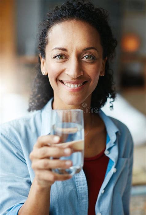Hydrate To Feel Great Portrait Of A Woman Drinking A Glass Of Water At