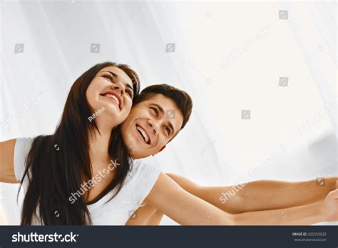 Happy Young Couple Having Fun Smiling And Relaxing In