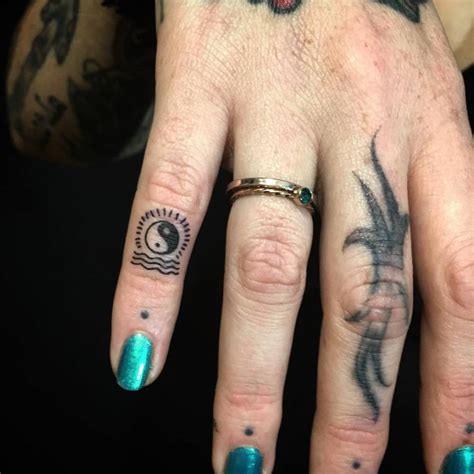 Small Yin Yang Tattoo On The Pinky Finger