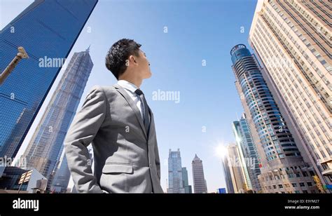 Young Business Man Standing Buildings In The Middle Stock Photo Alamy