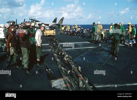 Flight Deck Crew Members Prepare To Set Up A Crash Barricade Aboard The