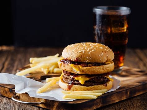 Premium Photo Burgers And French Fries On Wooden Table