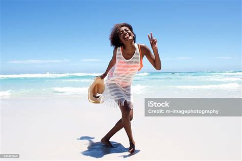 Cheerful Attractive Young African Woman Enjoying Walk On Beach Stock