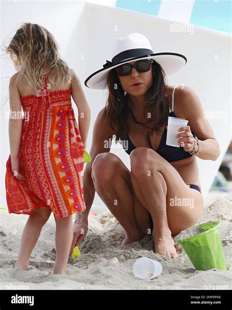 Bethenny Frankel Shows Off Her Slender Figure In A Navy Bikini And White Sun Hat As She Enjoys