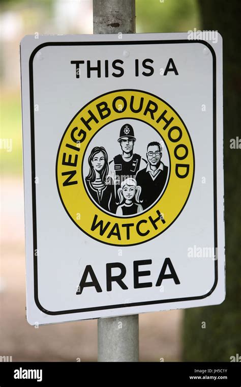 Members Of A Local Neighbourhood Watch Pictured Installing A Sign In A
