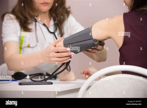 Cosmetology Beauty Clinic Doctor Checking Patients Blood Pressure