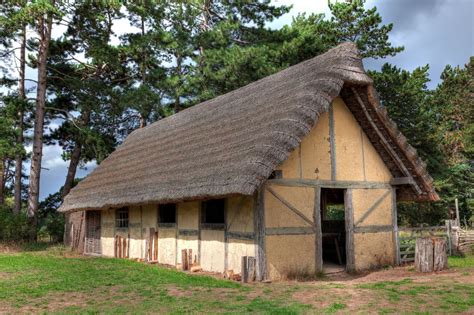 Photogrpah Of Reconstructed Ancient Building With Thatched Roof Anglo