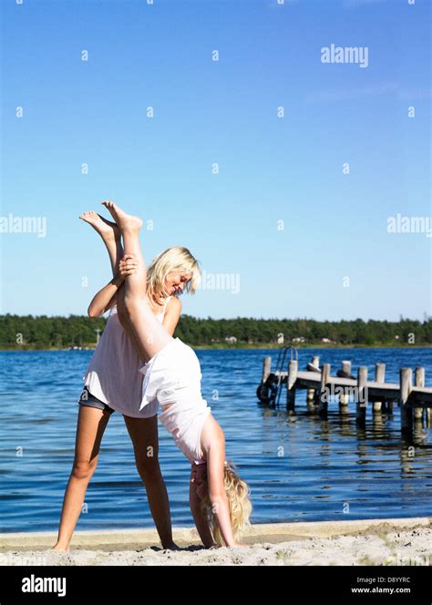 Two Girls Doing Gymnastic On The Beach Stock Photo Alamy