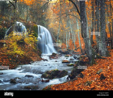 Beautiful Waterfall At Mountain River In Colorful Autumn Forest With