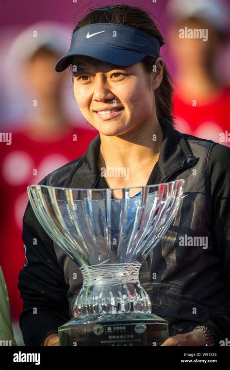 Chinese Tennis Player Li Na Shows Her Trophy After She Won The Champion