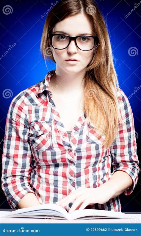 Calm Young Woman With Nerd Glasses Learning Diligently Stock Photo