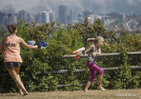 People Enjoy Splash Of Water During Flash Mob Water Fight In Vancouver