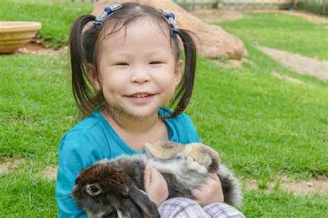 Little Girl Holding Rabbit In Park Stock Image Image Of Background