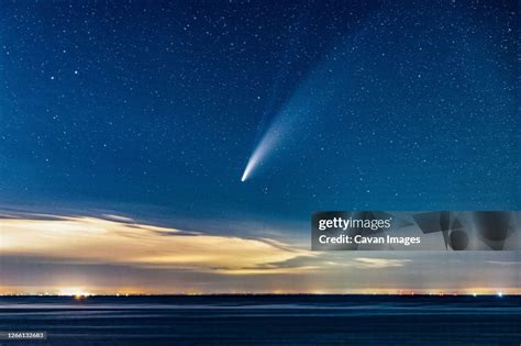 Comet Neowise Streaking Through The Sky Above The Ocean After Sunset