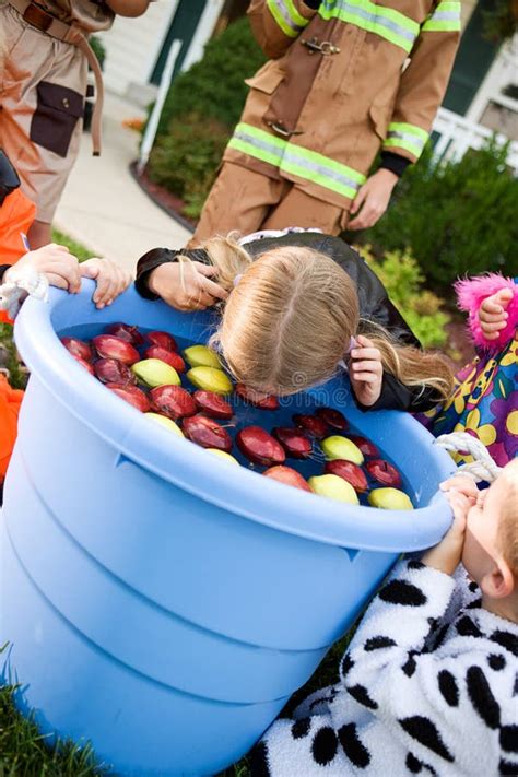 Halloween Girl Bobbing For Apples Stock Photo Image Of Anonymous