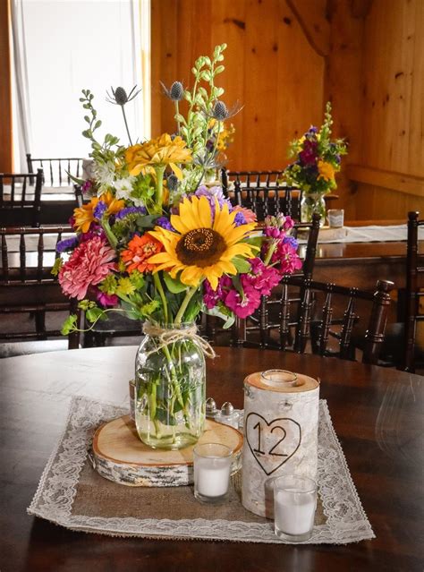 We Love These Country Wildflower Centerpieces Featuring Sunflowers Stock Zinnias A