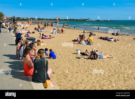 people enjoying sunbath at st kilda beach the most famous beach in melbourne australia stock