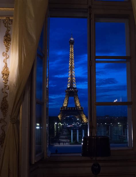 An Open Window Shows A Night View Of The Eiffel Tower In Paris Sept
