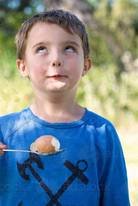 Image Of Little Boy Makes Funny Face With Egg And Spoon Austockphoto