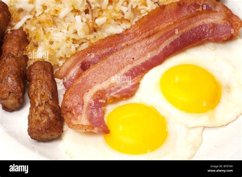 Breakfast Plate With Eggs Sunny Side Up Bacon Link Sausage And Hash