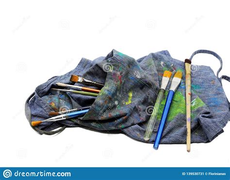 Artist`s Blue Apron Stained With Colors And Painting Brushes Stock