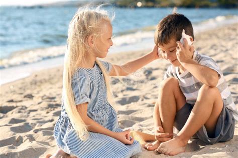 Little Children Playing With Sea Shells On Beach Stock Photo Image Of