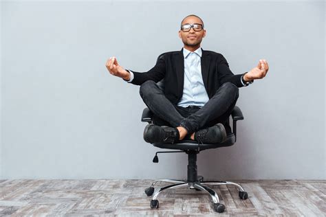Relaxed African Young Man Sitting And Meditating On Office Chair Ombody Healthombody Health