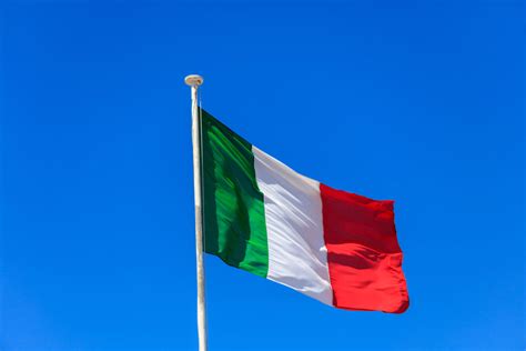 Italy Flag Italian Flag On A Pole Waving On Blue Sky Background