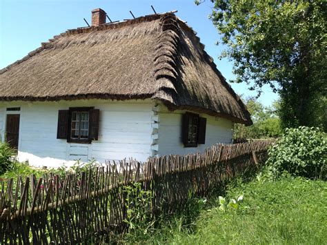 Traditional Polish Home With A Hay Roof Wood Structure And Stick Fence