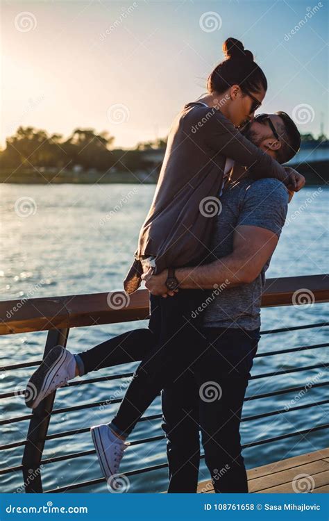 Man Lifting Up And Kissing His Girlfriend In A Sunset Stock Photo Image Of Love Happy