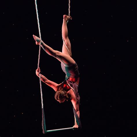 A Woman Is Doing Aerial Acrobatic Tricks On A Rope In The Dark