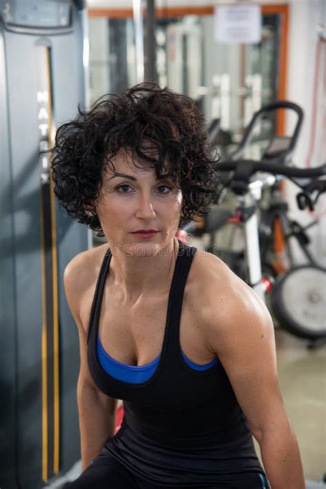 Front Portraits Of A Short Hair Brunette Woman Exercising At The Gym