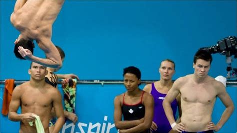 Athletes Look On As A Diver Practices A Routine During A Training