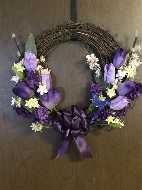 A Wreath With Purple And White Flowers On It