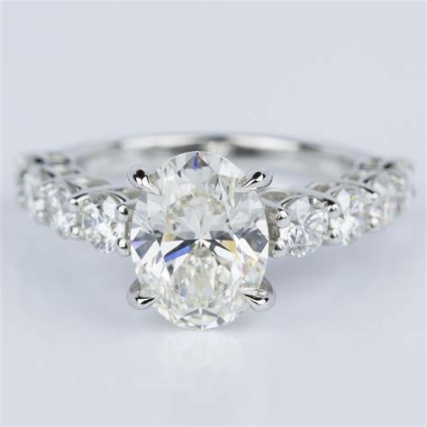 Oval Cut Engagement Ring With Large Side Diamonds In Platinum