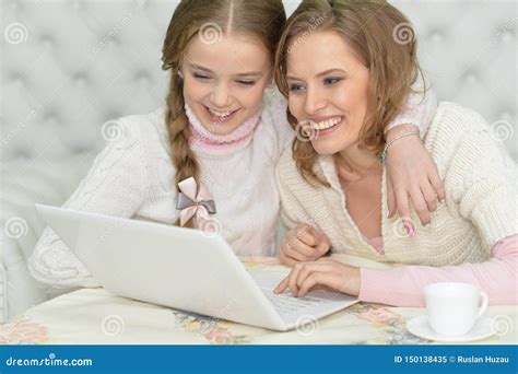 Portrait Of Mother And Daughter Using Laptop Together Stock Image