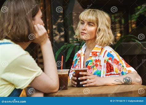 Image Of Two Women Talking And Drinking Soda While Sitting At Table Stock Image Image Of