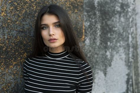 Frontal Portrait Of A Sensual Girl With Straight Brown Hair And Green