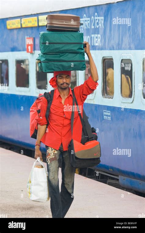 Porter Carrying Luggage At The Railway Station In Hyderabad India Stock