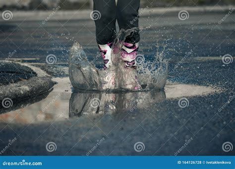 Girl Jumping Into Puddle Water Splash On Road Stock Photo Image Of