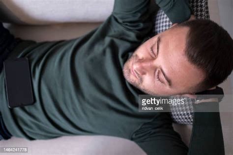 Man Falling Asleep On Couch Photos And Premium High Res Pictures