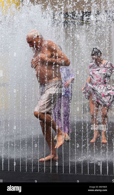 People Cooling Off In A Fountain Outside The Royal Festival Hall During